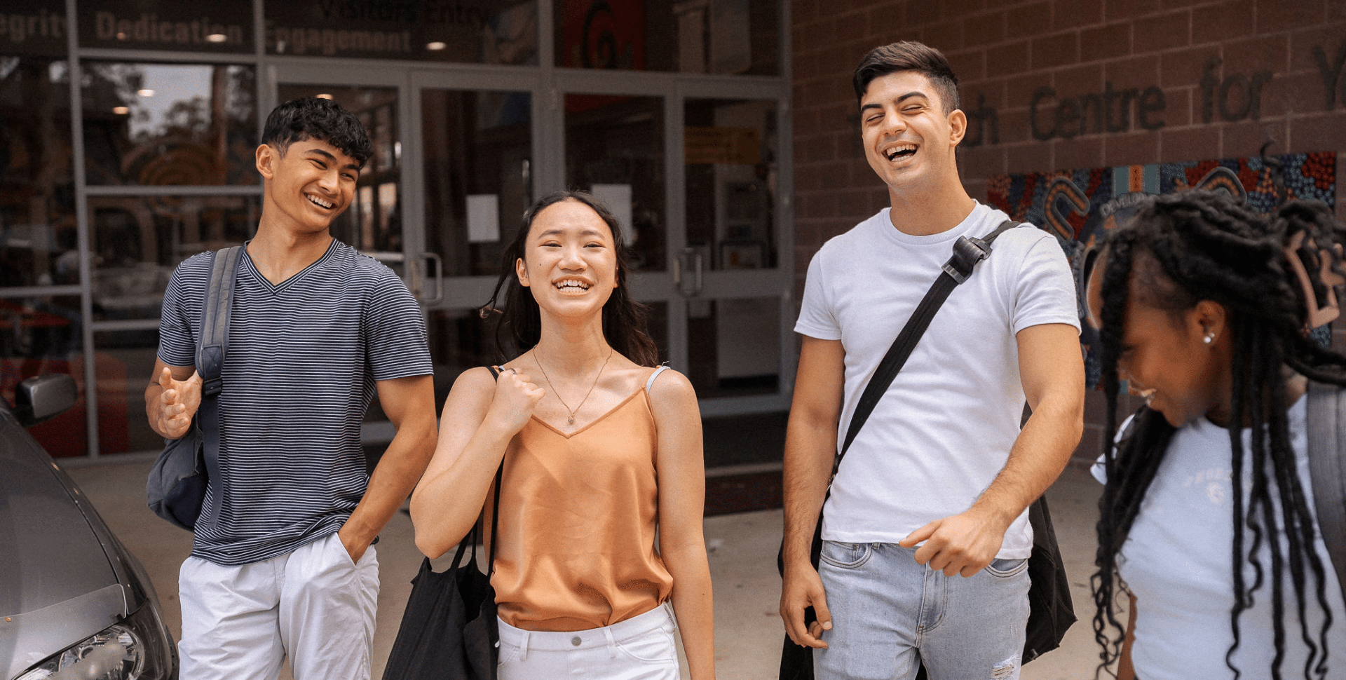 Group of four young people smiling