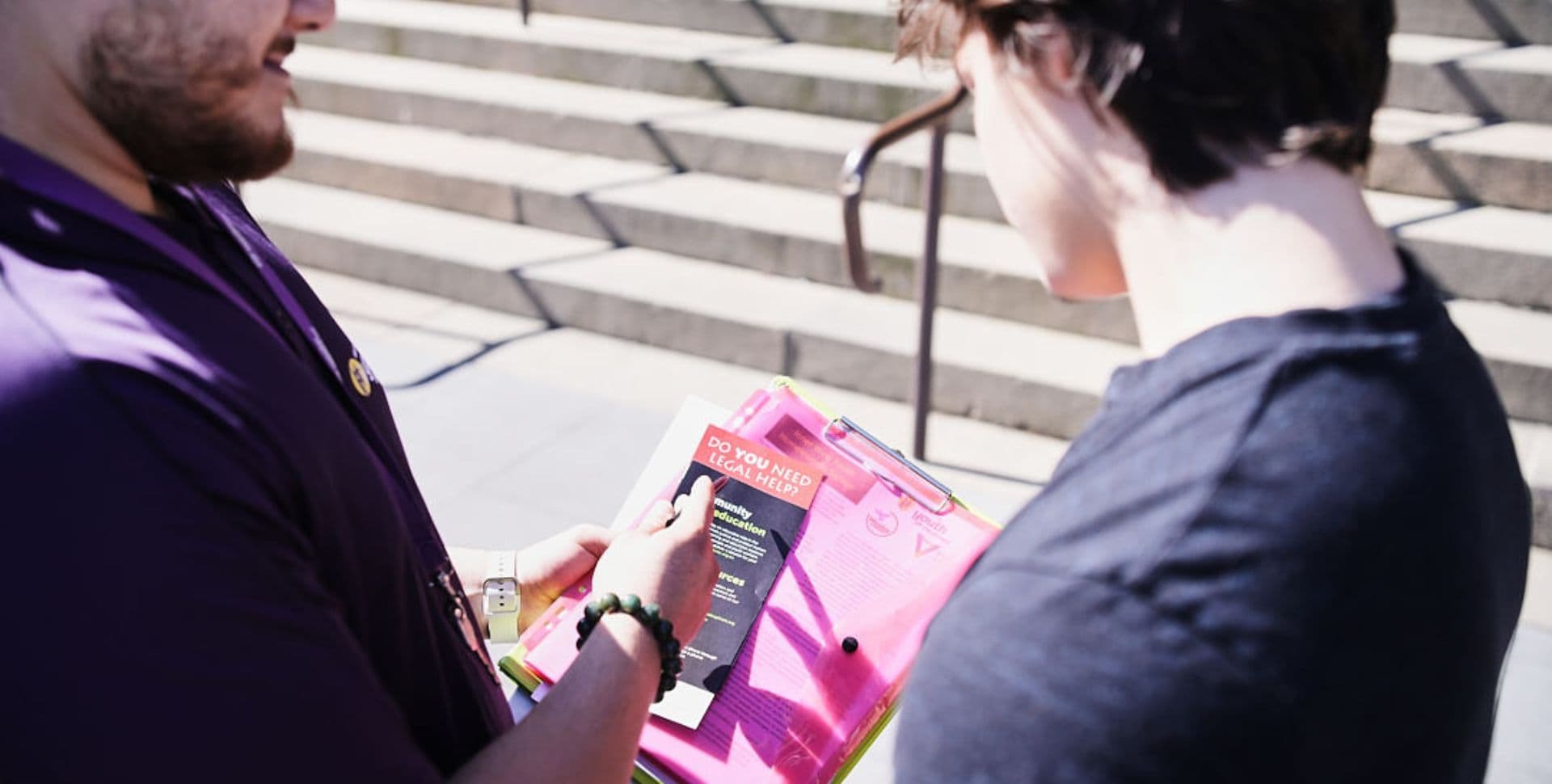 A young person and youth worker looking at brochures about the youth justice system