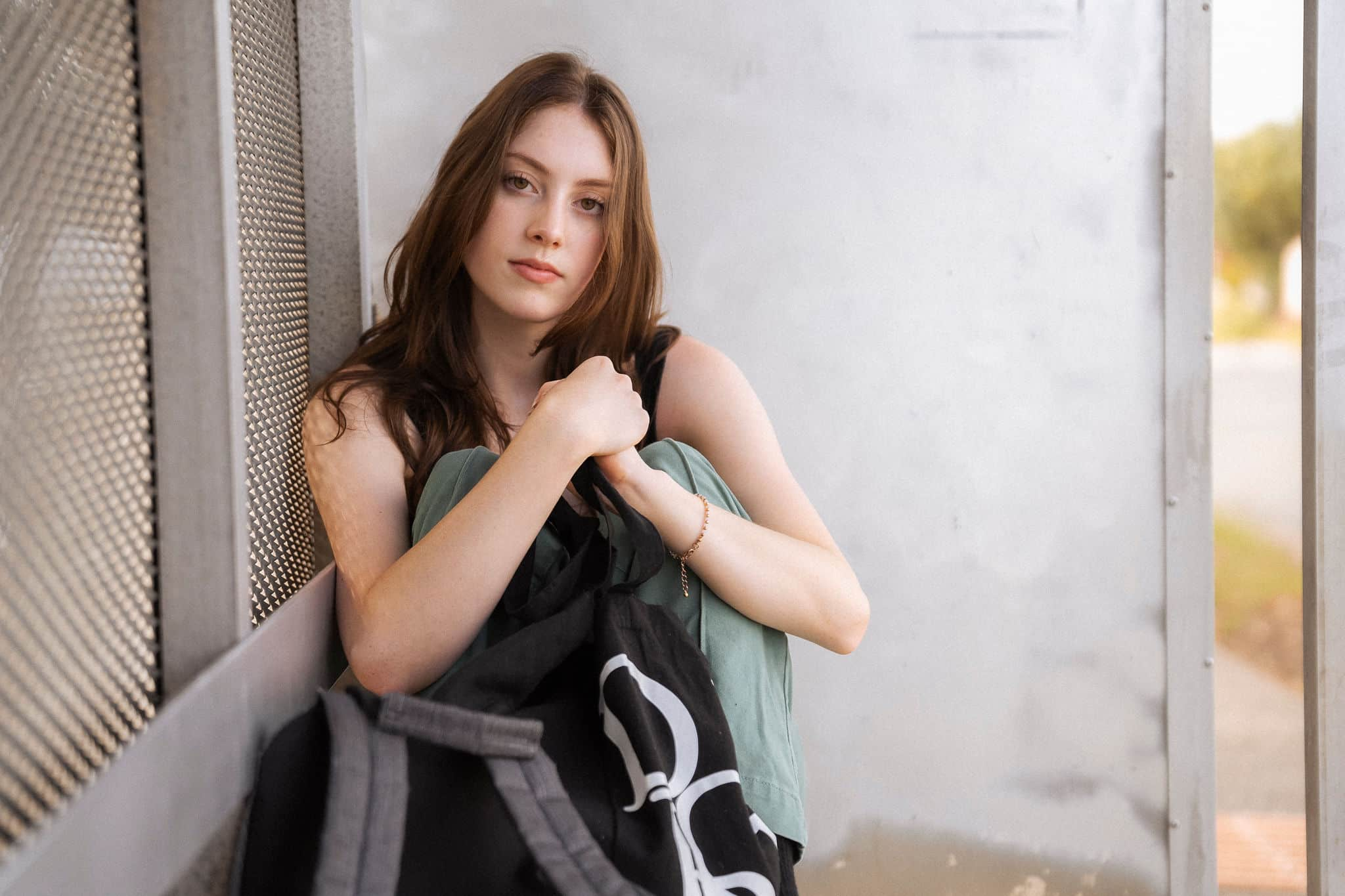 Homeless teenage girl seeking shelter at bus stop