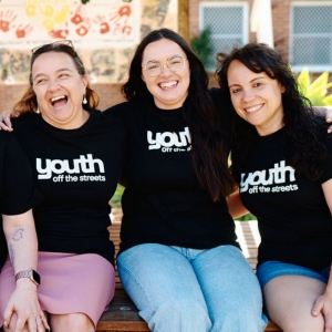 Youth Off The Streets employees arm-in-arm with each other